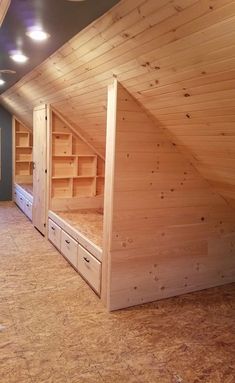 an unfinished attic with wooden walls and flooring