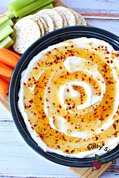 carrots, celery and crackers in a bowl