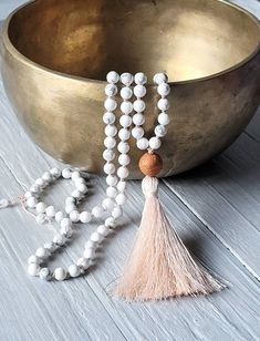 "CALMING EMOTIONS Howlite Mala, Hand Knotted Mala Necklace, 108 Mala Beads, Japa Mala, Buddhist Prayer Beads, Yoga Jewellery, Women's Yoga Gift, Meditation Jewellery, Crystal Healing, Knotted Tassel Mala Handmade with LOVE from a Yogi for a Yogi in Windermere :) This beautiful japa mala is hand knotted between each bead with a beautiful light pink Griffin Silk Thread 108 beads Size beads 6mm (108) in diameter. Bodhi Seed Bead from India is approx. 12mm in diameter. Light pink silk tassel is appr White 108 Beads Mala For Meditation, White Healing Mala With 108 Beads, White Mala With 108 Beads For Healing, White 8mm Beads Mala For Meditation, White Spiritual Mala With 8mm Beads, White Adjustable Mala With Gemstone Beads, Adjustable White Mala With Gemstone Beads, Adjustable White Gemstone Beads Mala, White Wooden Beads Jewelry For Meditation