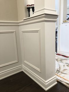 an empty room with white walls and wood flooring in the process of remodeling