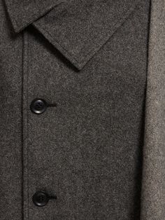 Front button closure. Model is wearing a size1 Designer Wool Coat With Double Button And Lapel Collar, Designer Long Sleeve Pea Coat With Button Closure, Semi-formal Wool Outerwear With Button Cuffs, Designer Notch Lapel Pea Coat With Button Closure, Classic Long Sleeve Outerwear With Buttons, Luxury Pea Coat With Notch Lapel And Button Closure, Designer Pea Coat With Notch Lapel And Hidden Buttons, Classic Business Wool Coat With Button Cuffs, Classic Wool Coat With Button Cuffs For Business