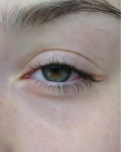 a woman's blue eye with long eyelashes