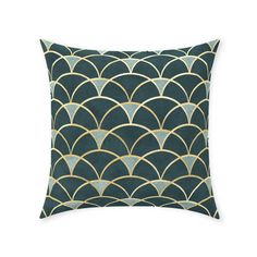 a green and gold pillow with an art deco design on it's front side