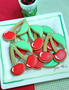 decorated cookies with red and green icing on a plate