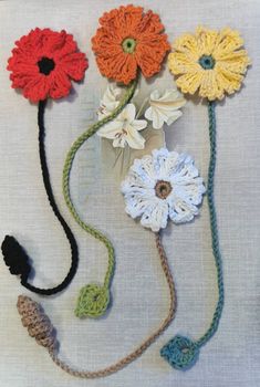 crocheted flowers are arranged on top of each other