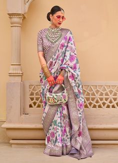 Indulge in luxury with our Exclusive Magnetic White Floral Printed Silk Saree! This exquisite saree is adorned with a delicate print and features a magnetic pallu and border, perfect for any festival. Elevate your style with this one-of-a-kind saree, designed for the modern woman in USA and UK. The unstitched blouse can be customized upto 44 inches. Do Note: All the accessories shown are for styling purpose only. Slight color variation may occur due to photographic reasons. Fall and Pico : Done Off White Saree, Lehenga Choli Wedding, Half Sleeve Blouse, Bridal Lehenga Choli, Printed Saree, Designer Lehenga Choli, Wear Saree, Blouse Material, Purple Silk