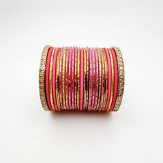 Beautifully designed bangles for any occasion. South asian bracelets come in a variety of styles, colors, and finishes. We at Banglez take creating the perfect bangle set for you to another level! You could say helping you find your favorite stack of bangles as one of our greatest missions. This bangle set was curated in house by one of our talented team members. We hope you love them as much as we do! Bohemian Stackable Wedding Bracelets, Adjustable Stacked Bangle Bracelets, Stackable Fusion Style Bangle Bracelets, Adjustable Round Cuff Bracelet For Festive Occasion, Traditional Pink Round Bracelets, Handmade Pink Bracelets For Festive Occasions, Handmade Pink Bracelets For Festive Season, Handmade Pink Festive Bracelets, Handmade Pink Bangle For Festive Occasions