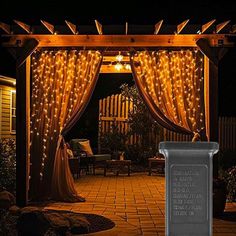 an outdoor gazebo with lights on it at night