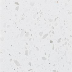 a white marble floor with small pieces of glass on it