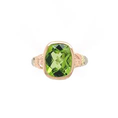 All of our jewelry is guaranteed authentic by our Graduate Gemologist of the Gemological Institute of America (GIA). 14k White Gold 3.24 Carat Cushion Cut Genuine Natural Peridot Ring (#J6551) Vintage 14k gold filigree ring with rose gold flowers and green gold leaves featuring a cushion cut peridot. This beautiful bright lime green color peridot weighs 3.24 carats and measures about 10mm x 8mm. This is a specialty cut cushion with a checkerboard top.  The ring fits a size 7.25 finger, weighs 1. Elegant Green Gemstones In 14k Gold, Luxury Peridot Rings With Accent Stones, Luxury Peridot Jewelry With Accent Stones, Luxury Green Cushion Cut Jewelry, Classic Green Gemstone With Center Stone, Elegant Green Peridot Gemstones, Classic Peridot Jewelry With Accent Stones, Green 14k Gold Gemstones For Anniversary, Luxury Hallmarked Peridot Jewelry