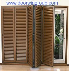 a room divider made out of wood shutters