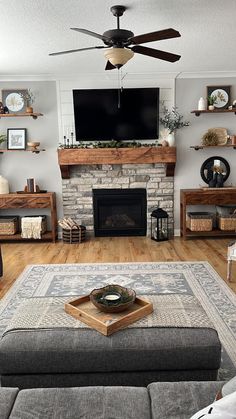 a living room filled with furniture and a flat screen tv mounted above a fire place