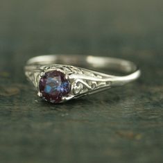 an antique style ring with a blue stone in the center