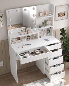 a white desk with drawers and shelves on the top is filled with makeup, personal care items