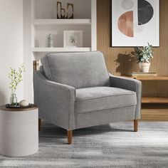 a living room with a gray chair and potted plant