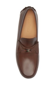 A mini double-Gancio bit tops the strap of this sophisticated take on a driving loafer crafted of calfskin with a hand-sewn sole covered with custom tread. Removable insole Leather upper and lining/leather and rubber sole Made in Italy Men's Designer Shoes Mens Designer Shoes, Driving Loafers, Cocoa Brown, Salvatore Ferragamo, Hand Sewn, Loafers Men, Designer Shoes, Calf Skin, Hand Sewing