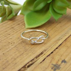 This Infinity Knot Ring is a dainty ring that shows your forever love, friendship, and appreciation for a special someone whether it be a wife, girlfriend, daughter, sister, or best friend. Solid Sterling Silver Infinity Knot Ring Band just over 1mm thick Modern Twist Infinity Stackable Rings As Gift, Sterling Silver Infinity Stackable Rings As Gift, Gift Sterling Silver Infinity Stackable Rings, Sterling Silver Infinity Ring Gift, Sterling Silver Infinity Ring, Infinity Shape Stackable Fine Jewelry Rings As Gift, Fine Jewelry Infinity Stackable Rings As Gift, Fine Jewelry Stackable Infinity Rings As Gift, Classic Infinity Stackable Rings As Gift