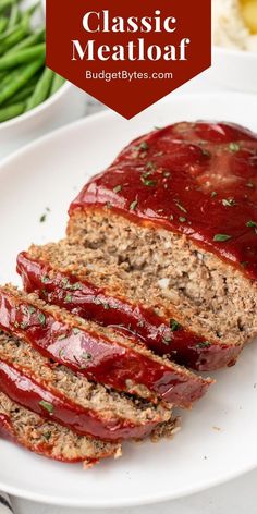 sliced meatloaf on a white plate with green beans