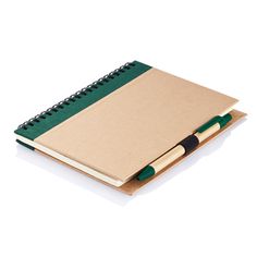 a notebook and pen sitting on top of each other