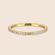 Simple and elegant, this alluring French Pave Eternity Ring will be a fabulous addition to your stack with its subtle, minimalistic design. This ring is ideal for stylish and fashionable modern women. This beautiful ring is the perfect choice for a wedding band or as a gift to a loved one on a special occasion. It is an ideal accessory for both casual events and formal occasions. Pair with a neutral dress of a darker tone. Features: Comfortable to wear Lightweight High quality Tarnish resistant Timeless Cubic Zirconia Bands For Promise Ring, Classic Moissanite Eternity Band For Promise, Classic Vvs Clarity Eternity Band, Classic Stackable Eternity Band For Formal Occasions, Elegant Stackable Eternity Band, Classic Half Eternity Band Promise Ring, Classic Diamond Eternity Band, Classic Cubic Zirconia Bands, Moissanite Half Eternity Round Band