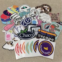 many different stickers and decals on the ground with one being used as a magnet