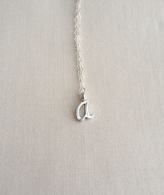 "Cursive initial necklace in sterling silver All items come in a cute jewelry box, ready for gifting. ► D E T A I L S Sterling silver chain + initial Initial | approx. 10-12mm in height depending on the letter. ► H O W TO O R D E R Please choose Length and Initial in the drop down menu options. ► G I F T I NG If you're sending an order directly to a loved one, I can add a sweet little note. Just leave it in the note section box upon checkout. ► P R O D U C T I O N + P R O C E S S T I M E My curr Silver Initial Pendant Necklace As A Gift, Hypoallergenic Sterling Silver Charm Necklace For Birthday, White Gold Charm Necklace With Initial Pendant For Gift, White Gold Initial Necklace For Gift, Silver Initial Necklace As Mother's Day Gift, White Gold Initial Pendant Charm Necklace As Gift, Sterling Silver Initial Necklace Gift, Silver Minimalist Charm Necklace For Birthday, Sterling Silver Initial Necklace For Mother's Day Birthday