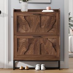 a wooden cabinet sitting in the corner of a room