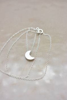 This lovely necklace makes a beautiful, lasting gift. I make this using 925 sterling silver chain and spring clasp. The crescent moon charm is a metal alloy with shiny silver finish and measures approximately 1/2 inch tall. It moves freely along the chain. Comes in a gift box, perfect for gift-giving. This piece looks great when paired with a star necklace. See 5th photo for both necklaces together. Listing is for moon necklace only but star necklace can be purchased here: www.etsy.com/listing/2 Silver Moon Necklace, Moon Necklace Silver, Long Drop Earrings, Moon Charm, Silver Moon, Lovely Necklace, 925 Sterling Silver Chain, Moon Necklace, Minimalist Necklace