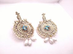 * This astonishing pair earing is a classical ornament, embellished with various elements and fine work. * The Bohemian inspired earrings feature craved motifs, Feruza stones and tinny dangling white beads. * The huge sized earrings would complete your stylish look and would add a pinch of ethnic touch to your modish look. * We assure you the High-Quality Product with On Time Delivery * Handmade Ornate Chandbali Jewelry, Traditional Single Brass Earring, Unique Beaded Earrings For Festive Occasions, Unique Festive Beaded Earrings, Bohemian Drop Clip-on Earrings For Wedding, Traditional Pendant Earrings For Celebration, Traditional Drop Beaded Earrings For Celebration, Traditional Beaded Drop Earrings For Celebration, Ornate Pendant Earrings For Festive Occasions