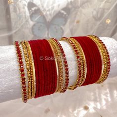 2 small half stacks of antique gold and maroon velvet bangles finished with stunning maroon stonework bangle on the ends. Ready to Ship! Packed in a small gift box. (No roll) Ruby Gold Bangle For Celebration, Red Ruby Bangle As Gift, Gold Ruby Bangle For Celebration, Celebration Ruby Gold Bracelets, Gold Ruby Bangle For Festive Occasion, Red Bollywood Bracelets For Celebration, Red Ruby Bracelet For Festive Occasions, Red Ruby Bangle For Wedding, Festive Red Ruby Bangle