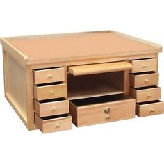 an unfinished wooden desk with drawers on the bottom and one drawer open to show it's contents