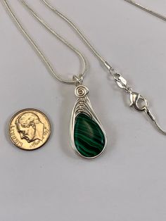 "This Malachite necklace is simple yet elegant. Malachite is a beautiful green color with unique striping/bands of color. I chose to enhance this beautiful smooth stone with a Celtic inspired silver wire design to let the natural beauty of the gemstone shine. This necklace is handmade by me with a synthetic malachite stone The necklace you will receive will be similar to the one in the picture, each stone is unique. The 4th photo in my listing shows the subtle variations of these Beautiful genui Adjustable Green Teardrop Jewelry, Green Adjustable Teardrop Jewelry, Adjustable Teardrop Green Jewelry, Green Wire Wrapped Adjustable Necklace, Green Wire Wrapped Pendant Necklace, Green Teardrop Wire Wrapped Jewelry, Green Wire Wrapped Teardrop Jewelry, Adjustable Green Wire Wrapped Necklace, Adjustable Green Sterling Silver Necklace