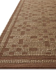 a brown and beige rug with squares on it