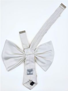 Our most elegant bow is now available in multiple sizes, with stunning hand embroidery for any big event. With hand-crafted flowers that add dimension against a supple silk backdrop, it's a truly standout accessory. Style with a strapless gown or top to highlight the stunning shape. Highlight the pink flower details with nice jewelery. Size 1: 14.5-17" neckband Size 2: 15-18.5" neckband Classic White Bow Tie For Wedding, Elegant White Bow Tie For Black Tie Occasions, Classic White Bow For Formal Occasions, White Classic Bow Tie, Elegant White Bow With Ribbon, Elegant White Ribbon Bow, Elegant Cream Bow For Parties, Elegant Cream Bow For Party, Classic White Standard Tie Bow