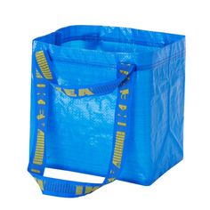 a blue shopping bag with yellow letters on the front and bottom, sitting against a white background