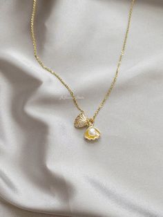 "△ DETAILS * 100% Genuine natural freshwater pearls, real pearl * Natural white color button shaped pearls, 5-5.5mm size, AAAA grade * 14K gold plated seashell/shell clam/oyster, with faceted cubic zirconia * 18K gold vermeil sterling silver chain, 18 inches (45cm) length * Delicate and daily wear necklace, perfect for yourself or as a gift * Ready for gifting, packed in a beautiful jewelry box * Handmade in USA ♥ Pearl Size: 5-5.5mm ♥ Pearl Shape: Button ♥ Pearl Color: White ♥ Chain Length: 18 Pearl In Shell Necklace, Pearl Clam Necklace, Cute Pearl Jewelry, Baroque Pearl Pendant Shell Necklace As Gift, Baroque Pearl Shell Necklace With Pendant As Gift, Pearl Shell Charm Jewelry, White Shell-shaped Pearl Pendant Necklace, Pearl Shell Necklace With Pearl Chain As Gift, Pearl Shell Necklace Gift