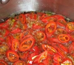 a pot filled with lots of red peppers