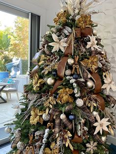 a decorated christmas tree with gold and brown decorations