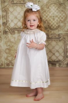 For the girl who always needs her pearls, Margaret is a 100% Cotton bishop with hand smocked bodice that features embroidered bows and seed pearls. This heirloom bishop dress also has accented satin ivory ribbons on the skirt and sleeve. Includes white slip. Classic flower girl, baptism and portrait dress. Measurement Toddler Flower Girl Dress, Toddler Flower Girl, Embroidered Bows, Flower Girl Dresses Vintage, Toddler Flower Girls, Portrait Dress, Southern Fashion, Classic Flower, Heirloom Dresses