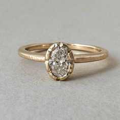 A testament to the enduring power of nature's love, this exquisite engagement ring is a delicate masterpiece. The oval lab diamond, a symbol of eternal beauty, sits nestled in a unique bezel setting that evokes the graceful petals of a wildflower in full bloom. Its organic shape and gentle curves capture the essence of nature's untamed spirit, while the diamond's brilliance reflects the radiant warmth of the sun. This is more than just a ring; it's a promise of a love as enduring and beautiful a Organic Engagement Rings, Nature Inspired Engagement Ring, Eternal Beauty, Engraved Flower, Bezel Engagement Ring, Flower Engagement Ring, Knot Earrings, Ring Pendant Necklace, In Full Bloom