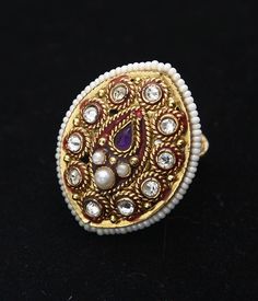 Gorgeous gemstone statement ring will wow at your next festive occasion 22k Yellow gold hypoallergenic, nickle and lead free Red enamel detail Pearl, Kundan and Amethyst gemstone Adjustable, one size fits most Gold Jeweled Ring Jewelry, Gold Jeweled Ring, Gold Jeweled Open Crystal Ring, Gold Jeweled Crystal Open Ring, Gold Jeweled Rings For Gift, Gold Jeweled Open Ring Jewelry, Unique Gold Enamel Ring With Gemstone, Gold Jeweled Crystal Ring Gift, Gold Jeweled Rings For Anniversary