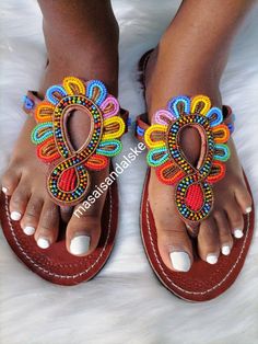 Maasai sandals is a unique simple beaded sandals made from real leather and has perfect flower made from Fines beads. Why you need the sandals? -it's light and durable hence it can be used during walk in the park, weekend outings, birthday party, beach party, working indoors and even driving since it's offers your feet enough ventilation and always stays fresh. -it's multicolored hence you won't be having problems of colour clashing. - it has a soft leather on the inner part which reduces fricti Handmade Sandals For Summer, Bohemian Toe Loop Sandals For Spring, Handmade Open Toe Flip Flops For Spring, Bohemian T-strap Sandals With Round Toe, Beaded T-strap Sandals For Beach, Bohemian Open Toe T-strap Sandals For Vacation, Multicolor Toe Loop Sandals For Summer, Beaded Adjustable T-strap Sandals, Bohemian Beaded Sandals For Spring