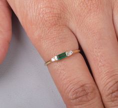 Emeralds are often associated with love and fidelity. Wearing this gemstone is believed to strengthen existing relationships, promoting loyalty and unity between partners. It can also attract new love into your life, as it radiates an energy of unconditional love and compassion. Gemstone: Lab Grown Emerald Shape/Size: Octagon 6x2.5MM  Finish Type: White rhodium/ yellow gold plating/rose gold plating / Solid14K Gold also available Ring Size: US Ring sizes 3-12  Metal Type: 925 Sterling Silver / S 14k Gold Emerald Cut Birthstone Promise Ring, 14k Gold Emerald Cut Promise Ring, Dainty Emerald Stackable Rings For Anniversary, 14k Gold Birthstone Ring For Anniversary, Emerald Cut, Dainty Emerald Anniversary Ring, 14k Gold Emerald-cut Birthstone Ring For Anniversary, Emerald Cut Birthstone Ring In 14k Gold For Anniversary, Three Stone Baguette Cut Diamond Ring As Gift, Dainty 14k Gold Emerald Ring For Anniversary