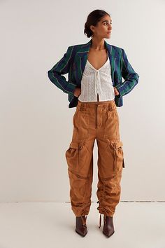 So slouchy and forever cool, this new take on the classic cargo silhouette from our We The Free collection will be a staple for seasons to come. **Fit:** Low-slung, wide cargo silhouette **Features:** Zip fly and hidden closure, oversized workwear pockets, tassel tie detailing, smocked waistband for ease **Why We ❤ It:** Sporty with classic sneakers or toughened-up with moto boots, this pair has endless ways to wear. | We The Free Everglades Utility Trousers at Free People in Brown Sugar, Size: Fall Utility High-waisted Cargo Pants, Fall Utility Parachute Pants With Tapered Leg, High-waisted Cargo Pants With Patch Pockets For Fall, Trendy Fall Cargo Pants With Flap Pockets, Fall Tapered Leg Cargo Pants With Pockets, Fall Cargo Parachute Pants With Tapered Leg, Fall Parachute Cargo Pants With Tapered Leg, Fall Utility Cargo Pants With Tapered Leg, Fall Utility Tapered Leg Cargo Pants