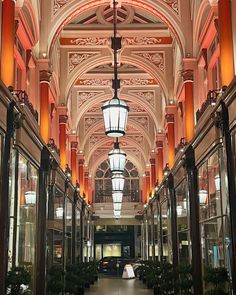 the inside of a large building with many windows and lights on each side of it