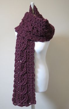 a crocheted purple scarf on a mannequin headpiece with a white dummy in the background