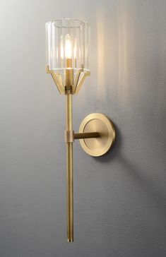 a wall light that is on the side of a wall next to a gray wall