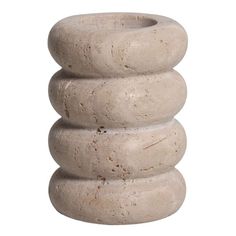 a stack of three stone vases sitting on top of each other in front of a white background