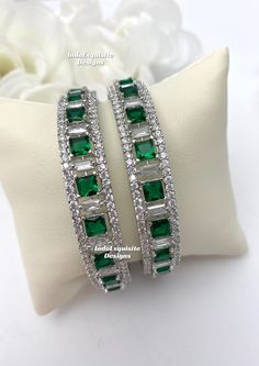 silver green American Diamond Bangles (2 pcs.) Kade/ CZ Kangan/Indian Wedding jewelry/Reception bangles set/Zircon kade All items are shipped from Brampton, Ontario, Canada. If you need your item by a certain day, please reach out to us for express delivery option before placing the order so that we can update the shipping for you. Standard shipping/delivery timeline Below are the estimated delivery times after the order is shipped/dispatched.  ---> USA delivery timeline * 4-8 business days to major urban centers in USA. It may take 2-3 days extra to remote locations ---> Canada delivery timeline  * 2-3 business days - GTA  & Montreal  * 2-4  business days - Rest of Ontario/Quebec * 4-8 business days-  Rest of Canada (Please consider 1-2 extra business days to very remote locations)    --- Green Bangle Bracelets For Wedding, Elegant Green Bangle With Stone Work, Green Cubic Zirconia Jewelry With Stone Work, Silver Emerald Bracelets For Weddings, Formal Green Emerald Bangle, Green Cubic Zirconia Hand Set Bracelets, Green Cubic Zirconia Bracelets With Hand Set, Green Bangle Jewelry For Anniversary, Green Bangle For Anniversary