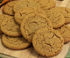 a pile of cookies sitting on top of a wooden cutting board